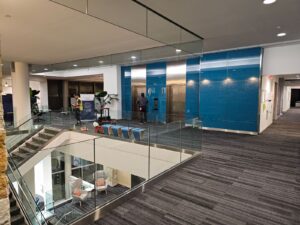 glass railing in front of elevators surrounding stairs